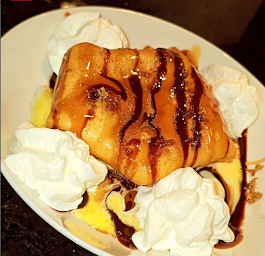 Fried Ice Cream- Filled with vanilla ice cream. Topped with brown cinnamon sugar, Carmel and Chocolate